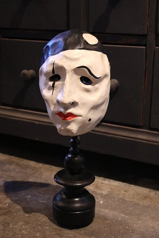 Decorative, old clown mask in painted papier-mâché mounted on old black painted wooden base...