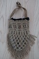 An antique beautiful handbag handmade of flax, and it has the characteristic colour of  flax The closing is made with a string, handmade as well