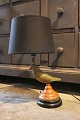 Decorative, old table lamp in the shape of a small bird in painted brass that 
holds the lampshade...