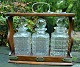Pegasus – Kunst - Antik - Design presents: English tantalus with three crystal decanters, 19th century.