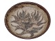 Royal Copenhagen art potteryLarge bowl featuring a stylized flower and sweeping leaves in relief, by Gerd Bøgelund.