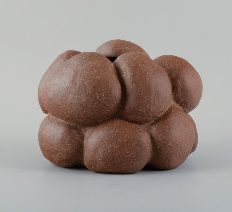 Christina Muff, Danish contemporary ceramicist (b. 1971). Golden brown unglazed stoneware clay vessel with specks. Organically shaped. Clear glaze inside.